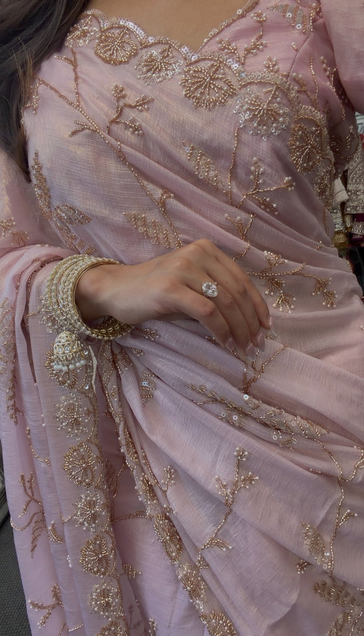 Blush pink chiffon saree with gold sequin embroidery and scalloped border draped in traditional style — view 4