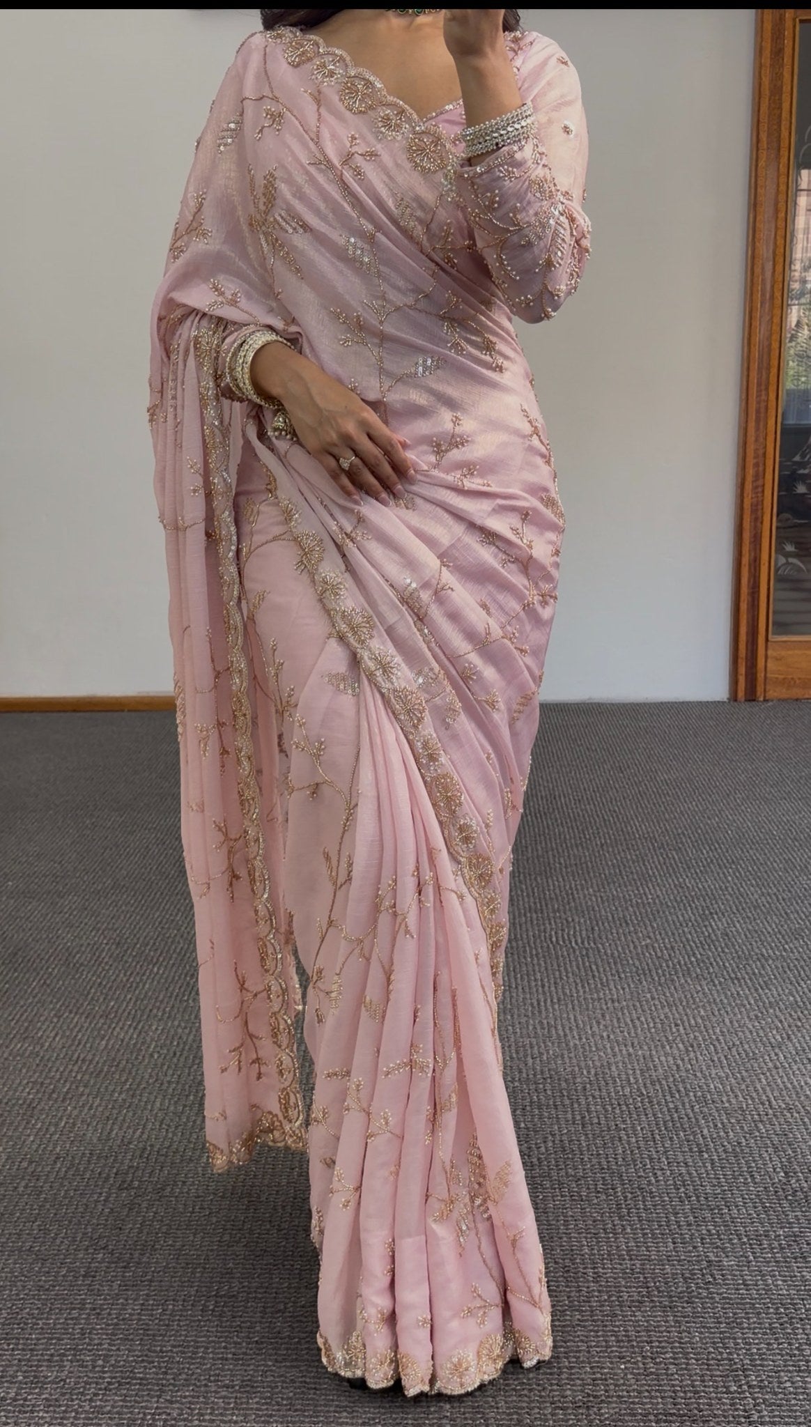 Blush pink chiffon saree with gold sequin embroidery and scalloped border draped in traditional style — view 5