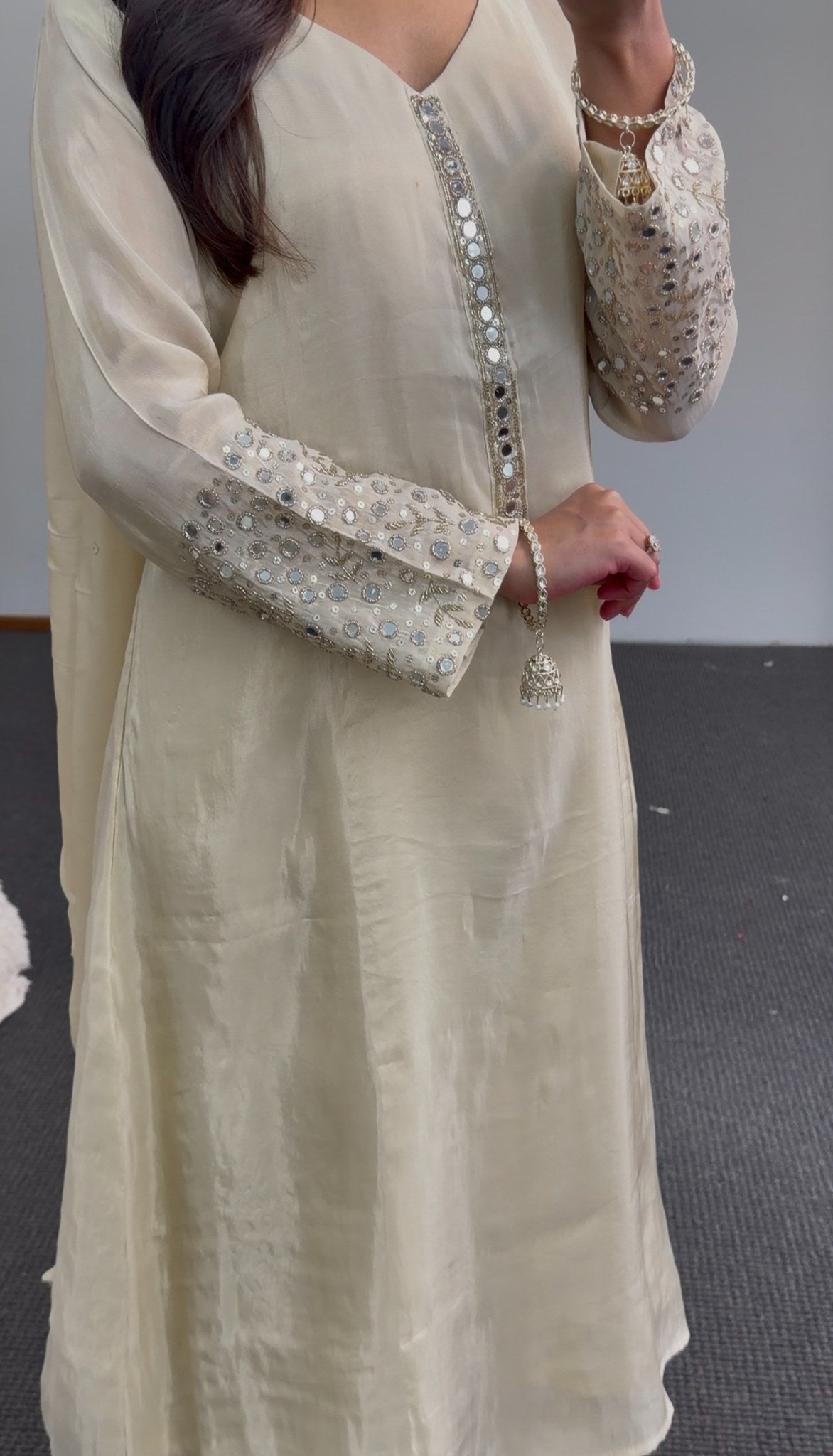 Ivory A-line kurti set with mirror work embroidered sleeves, embellished placket, and matching flowing dupatta — view 4