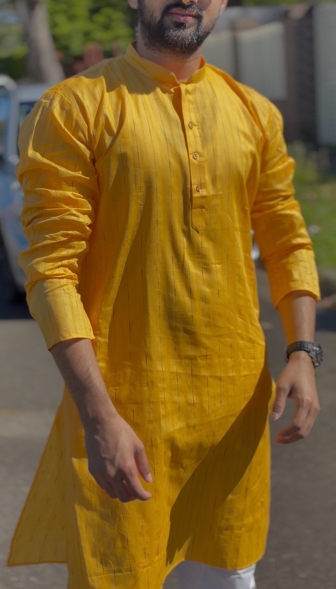 Mustard yellow men's kurti with mandarin collar and subtle self-striped texture, full sleeves, worn outdoors