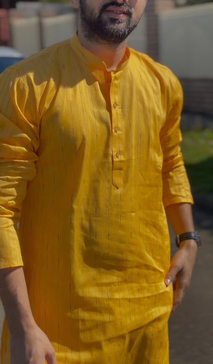 Mustard yellow men's kurti with mandarin collar and subtle self-striped texture, full sleeves, worn outdoors — view 2