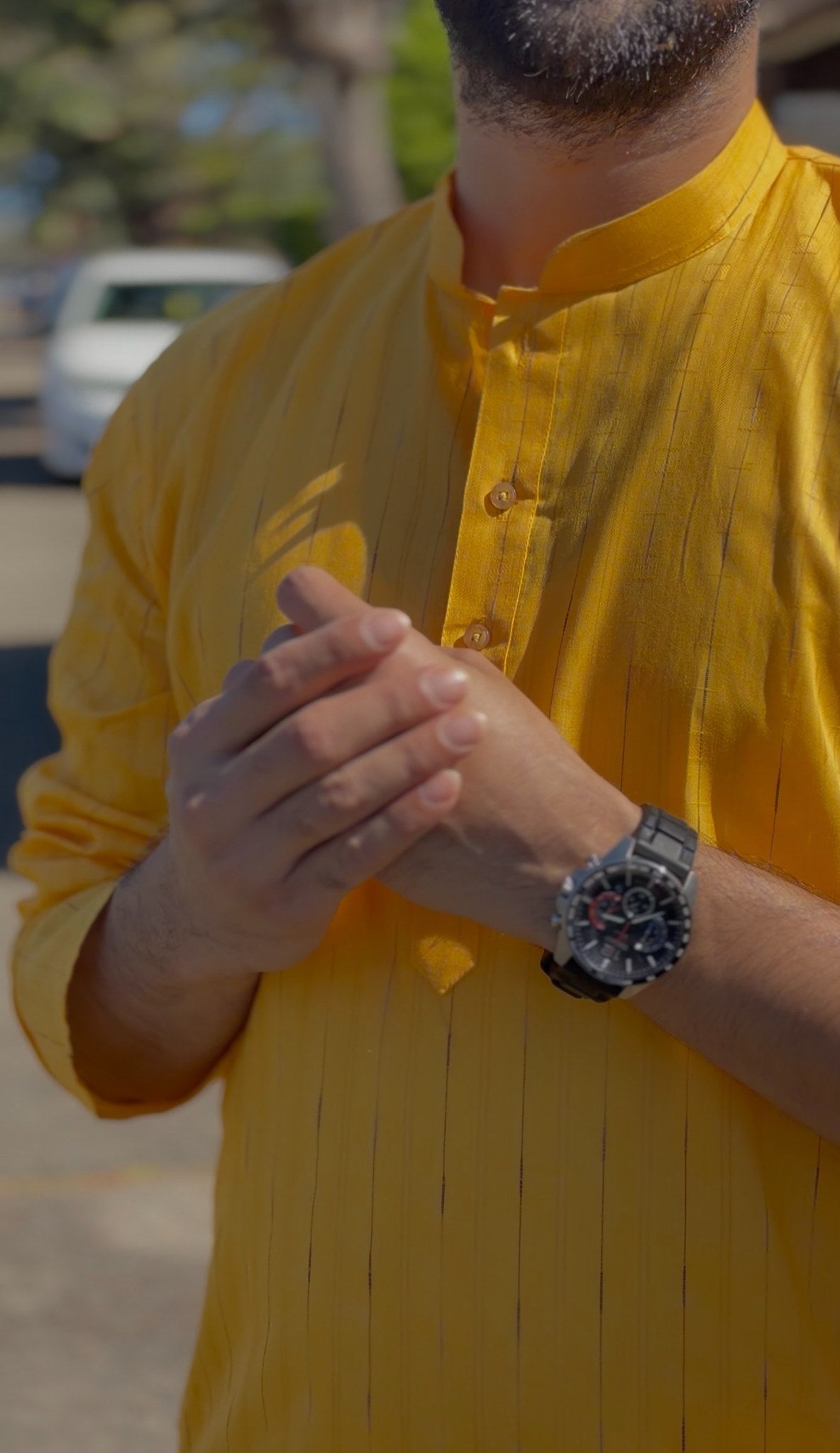Mustard yellow men's kurti with mandarin collar and subtle self-striped texture, full sleeves, worn outdoors — view 3