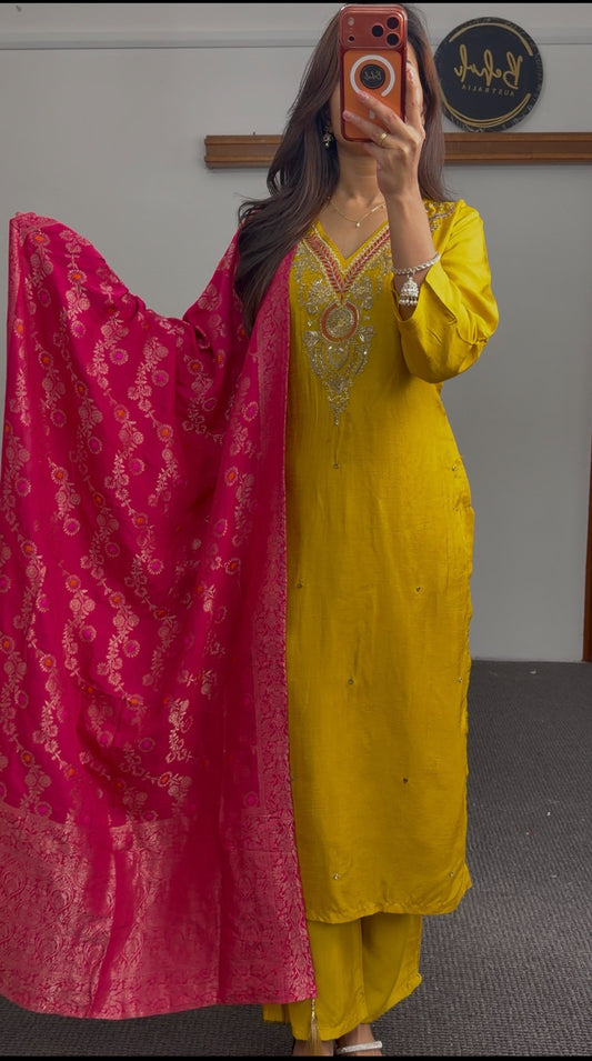 Mustard yellow kurti set with embroidered neckline paired with fuchsia pink Banarasi-style dupatta featuring gold floral