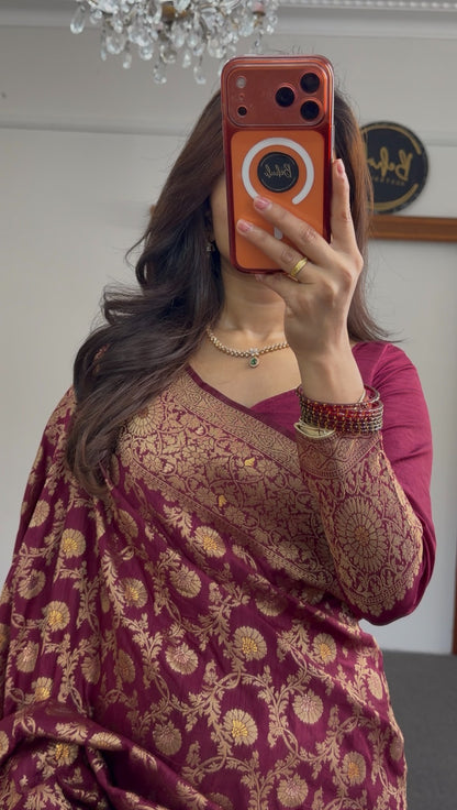 Maroon saree with gold zari floral weave, pallu draped over shoulder, worn with matching maroon blouse — view 3