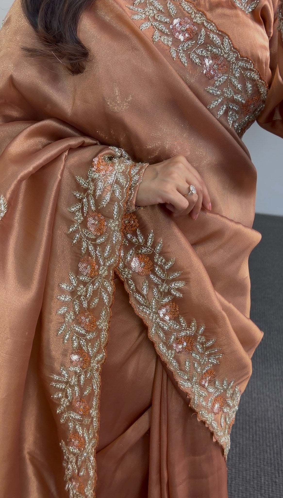 Copper satin saree with floral embroidered border and sequin detailing draped over shoulder — Behuli Australia — view 3