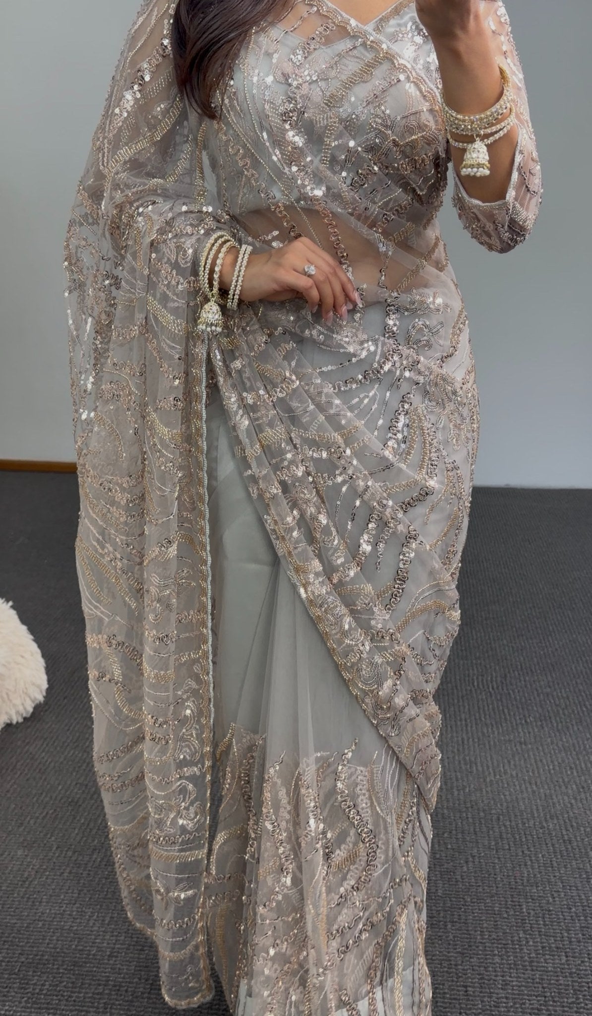 Grey net saree with gold sequin embroidery and embellished pallu draped over matching underskirt — Behuli Australia — view 5