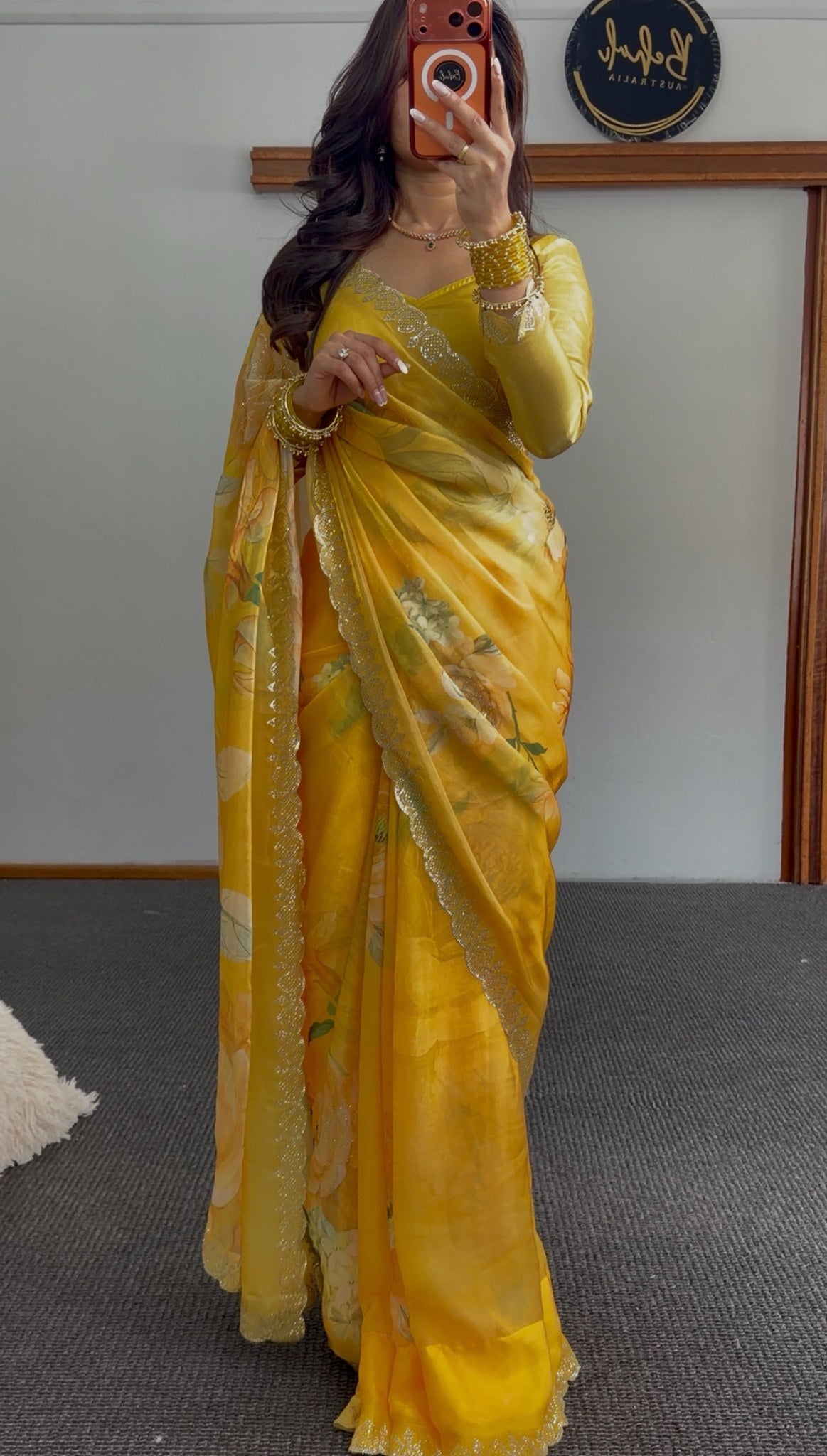 Mustard yellow floral print saree with scalloped gold sequin border, draped elegantly — Behuli Australia — view 3