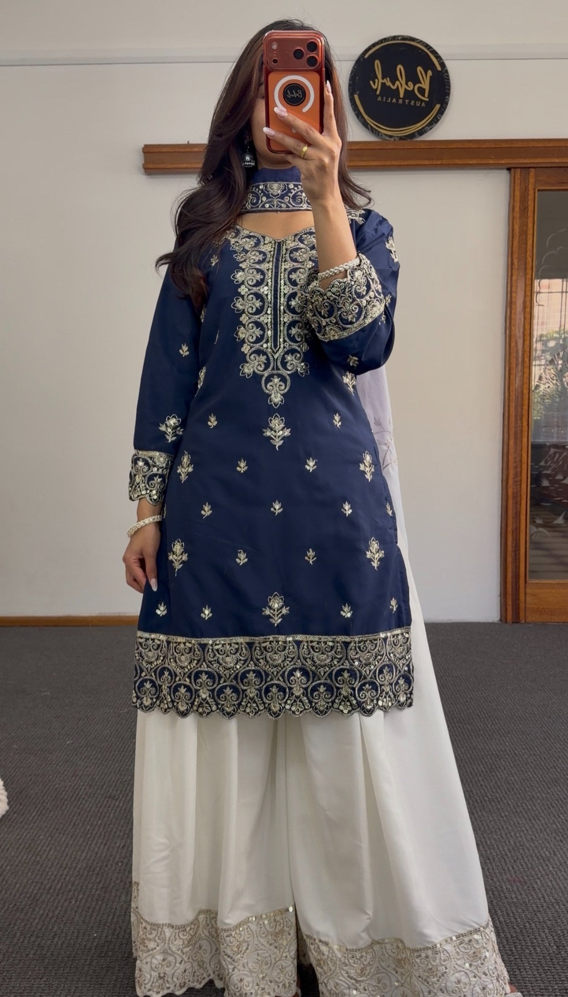 Navy blue palazzo suit set with gold zari embroidery on neckline and hem, paired with white embroidered palazzo pants and