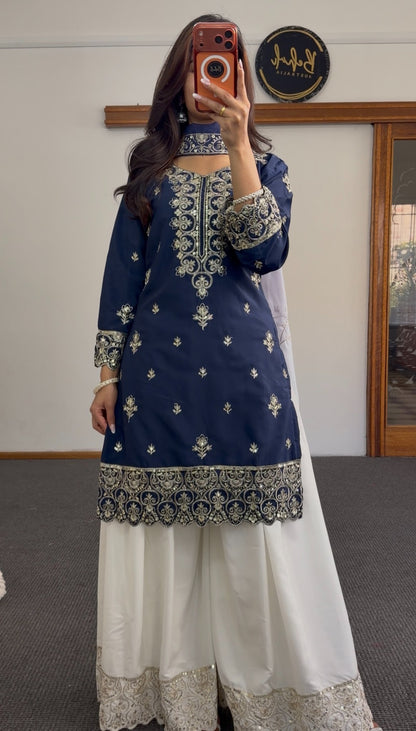Navy blue palazzo suit set with gold zari embroidery on neckline and hem, paired with white embroidered palazzo pants and