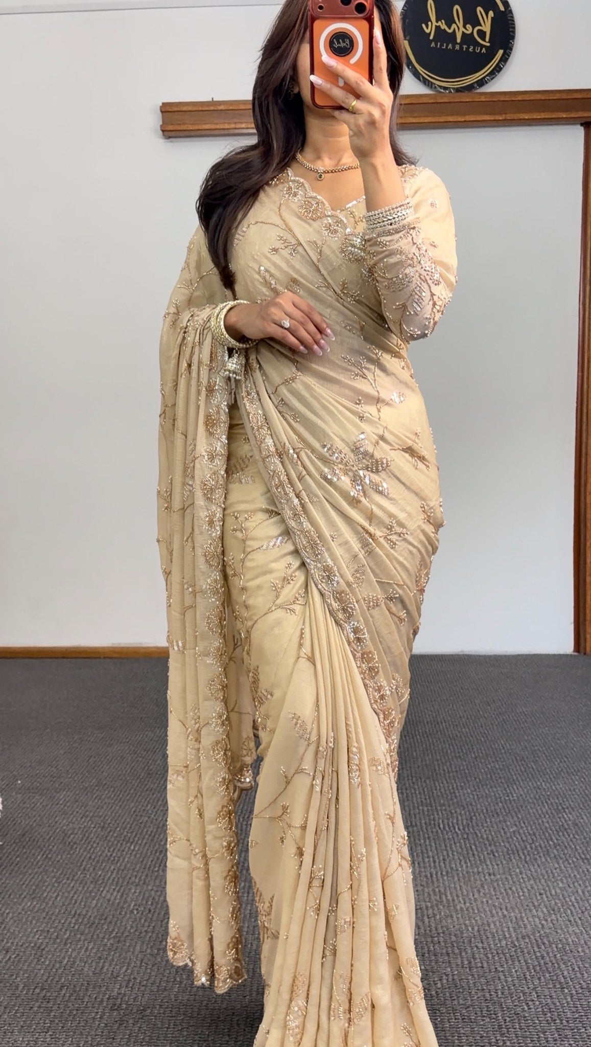 Ivory saree with gold floral embroidery and sequin detailing, draped with matching embellished pallu — Behuli Australia